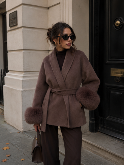 Front view of women's A-line wool coat with fur trim in white