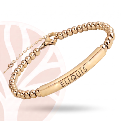 Both silver and gold Eliquis medical alert bracelets placed side by side on neutral surface
