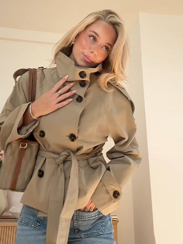 Women's belted trench jacket in khaki with adjustable cuff straps and shoulder tabs