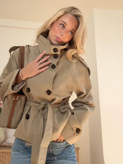 Women's belted trench jacket in khaki with adjustable cuff straps and shoulder tabs