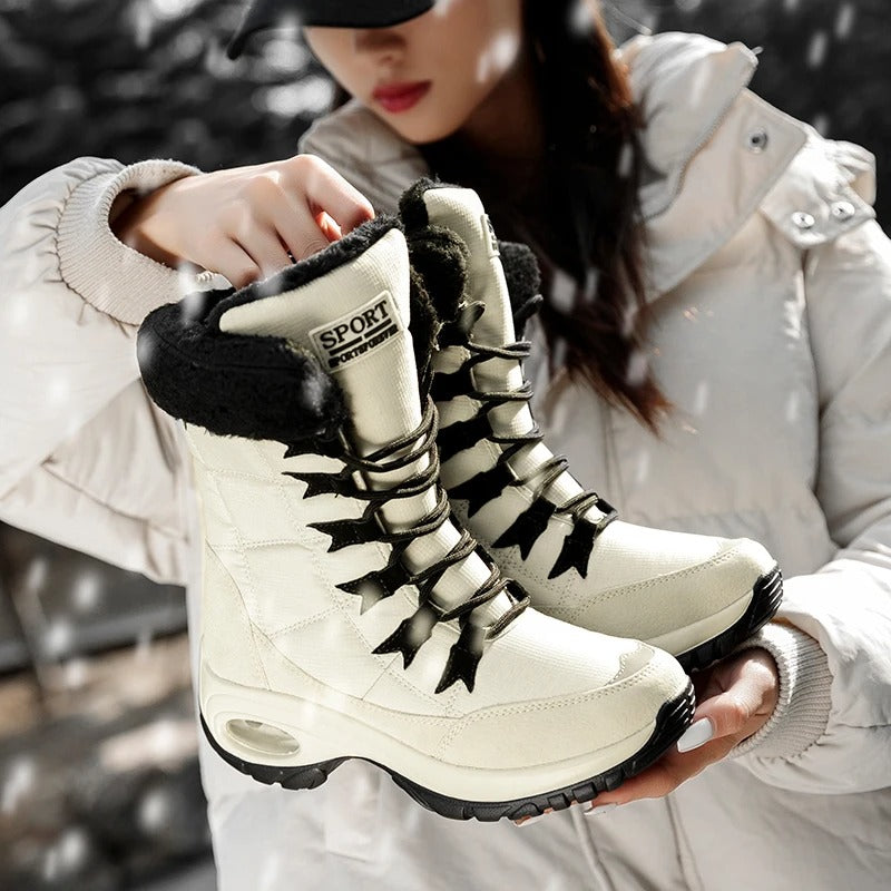 Sylvara black waterproof boots on wet cobblestone surface