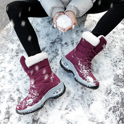 Sylvara waterproof boots worn with jeans in a snowy outdoor setting