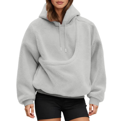 Beige pet carrier hoodie worn by woman with small dog inside