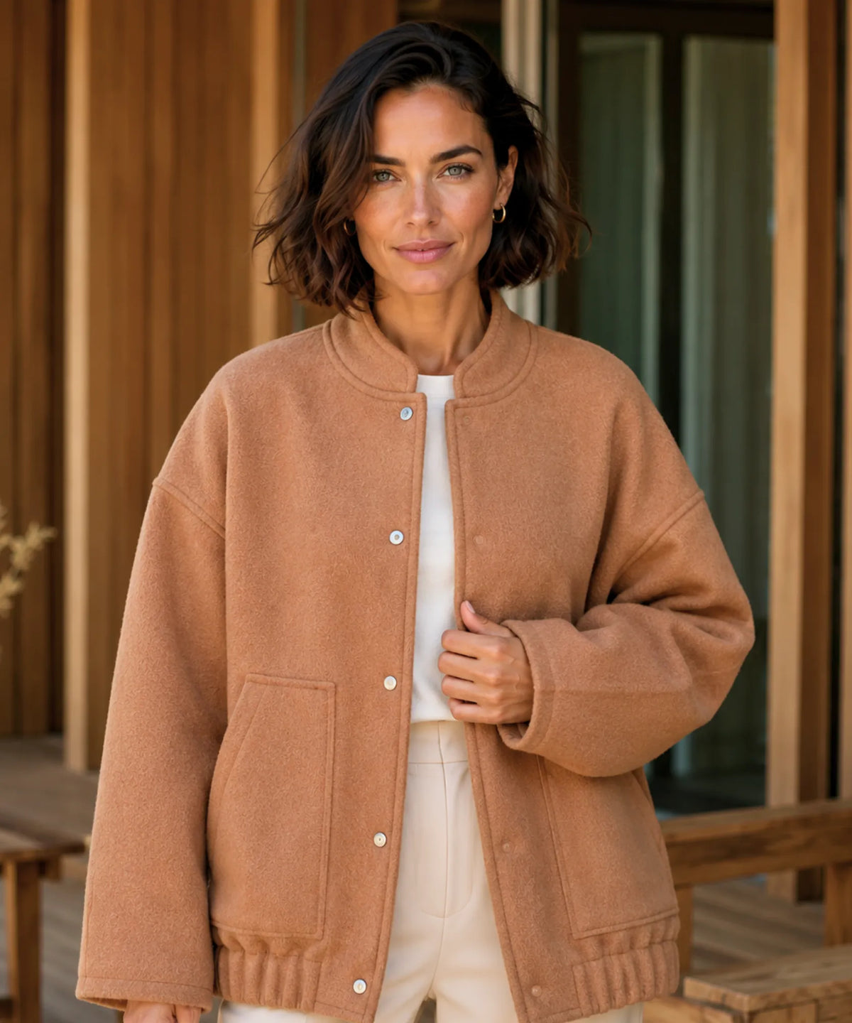 Side view of women's oversized bouclé bomber jacket showing side pockets