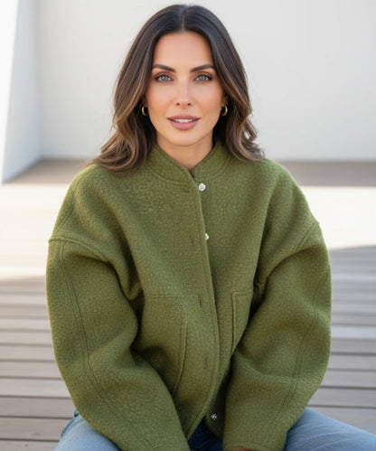 Women's bouclé bomber jacket in ivory worn as a layering piece