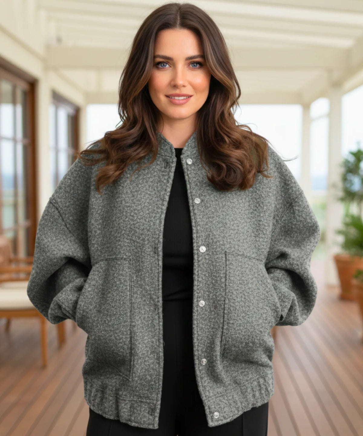 Model wearing yellow bouclé bomber jacket highlighting oversized cut
