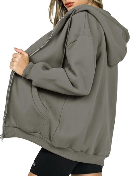 Close-up of zip detail on women's oversized casual hoodie in black