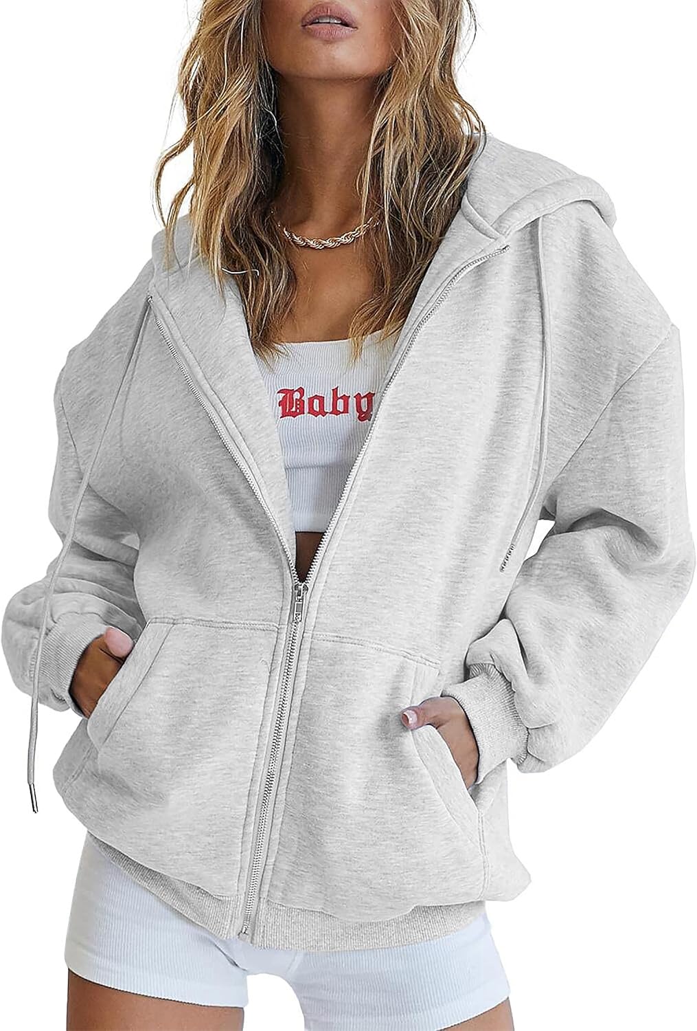 Detail shot of front pockets on women's oversized hoodie in grey-green