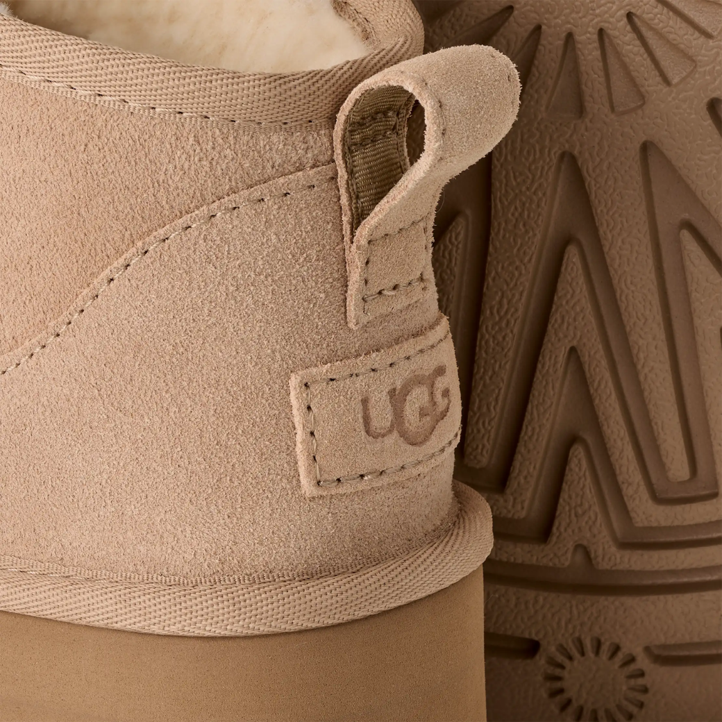 Avery boots in sand worn with leggings, lifestyle shot
