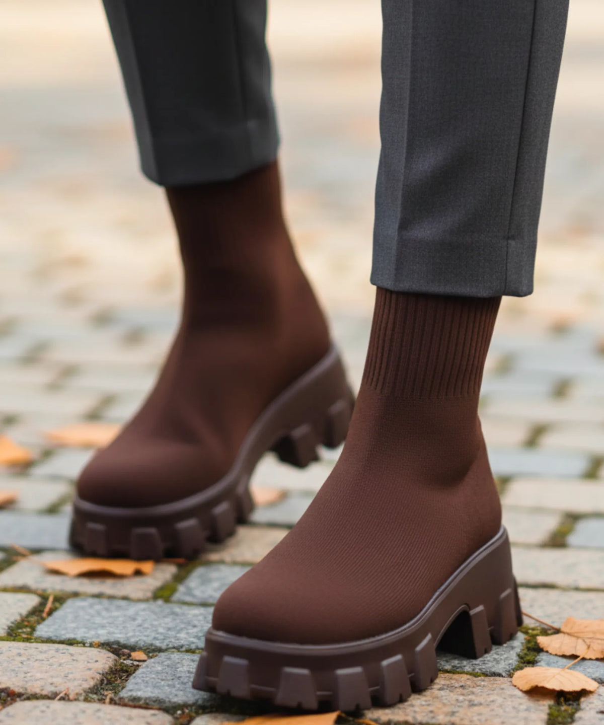 Pair of women's black slip-on knit boots with chunky platform sole