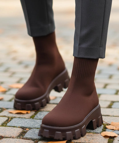Pair of women's black slip-on knit boots with chunky platform sole
