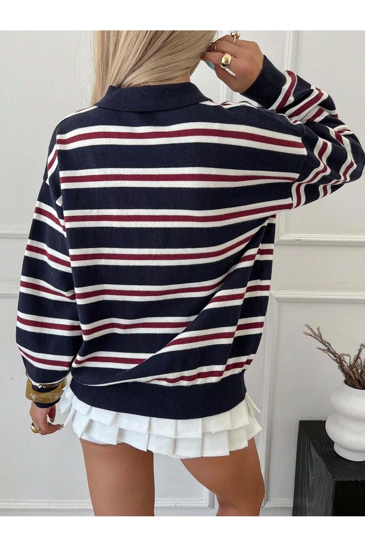 Detail shot of striped pattern on women's navy blue knit sweater
