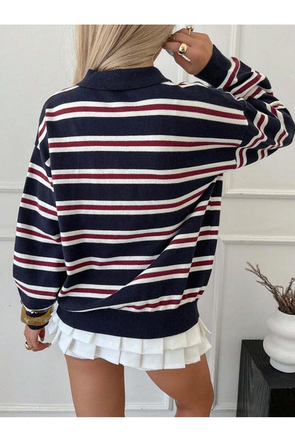 Detail shot of striped pattern on women's navy blue knit sweater
