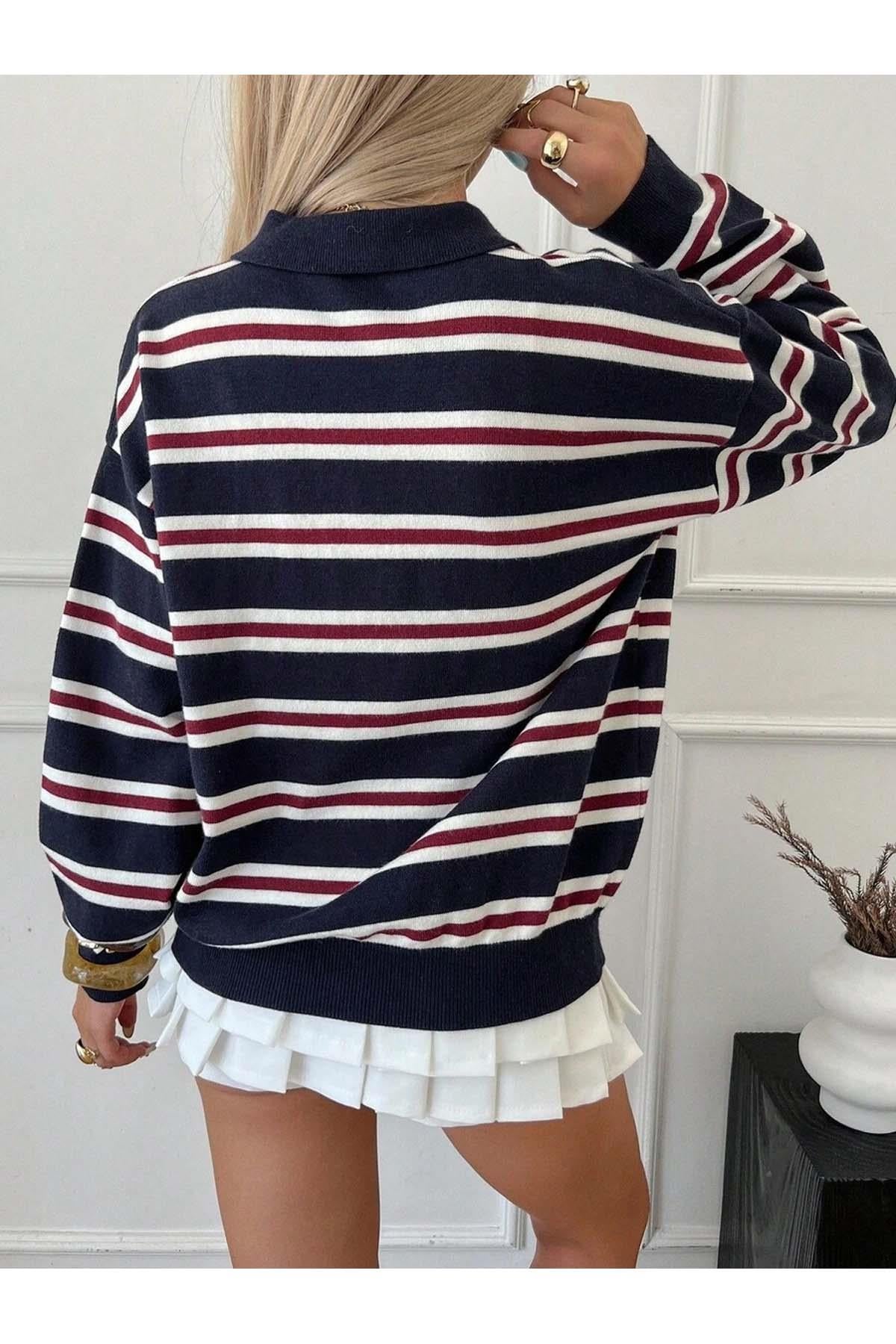 Detail shot of striped pattern on women's navy blue knit sweater