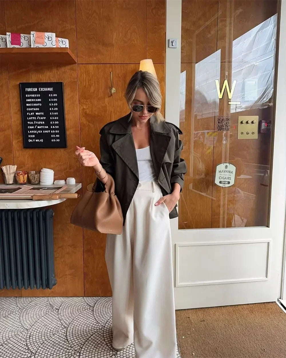 Khaki crop jacket layered over casual outfit for city street style look