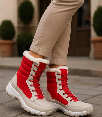 Black and white women's snow boots with reinforced stitching and sporty silhouette