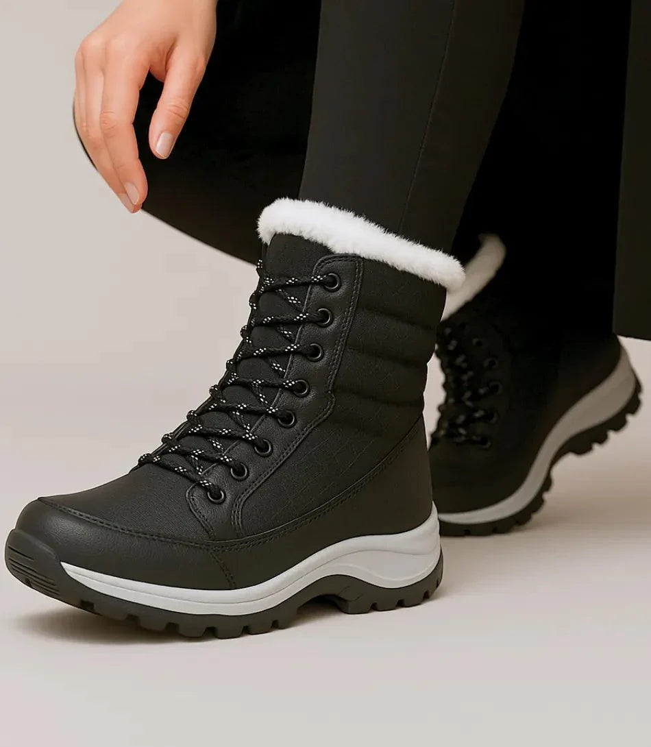 Front view of women's lace-up waterproof snow boots in black and white