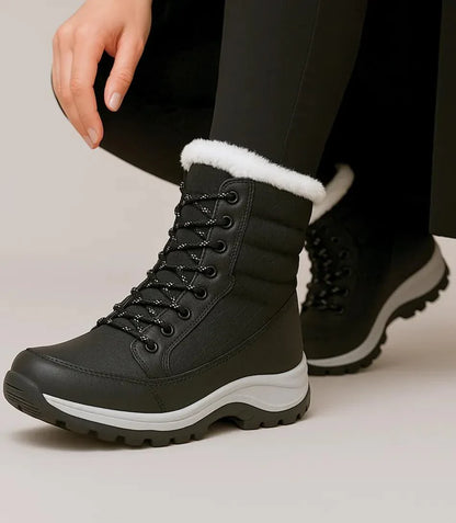 Front view of women's lace-up waterproof snow boots in black and white