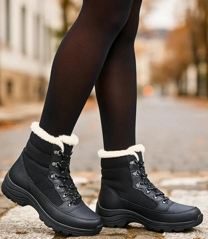 Navy blue women's winter boots with deep-tread rubber outsole for icy surfaces