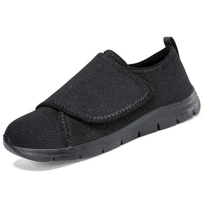 Rear view of black velcro sneakers with pull tab