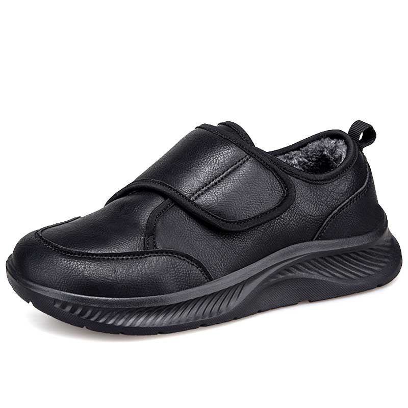 Side view of black velcro nursing sneakers with stripe texture upper